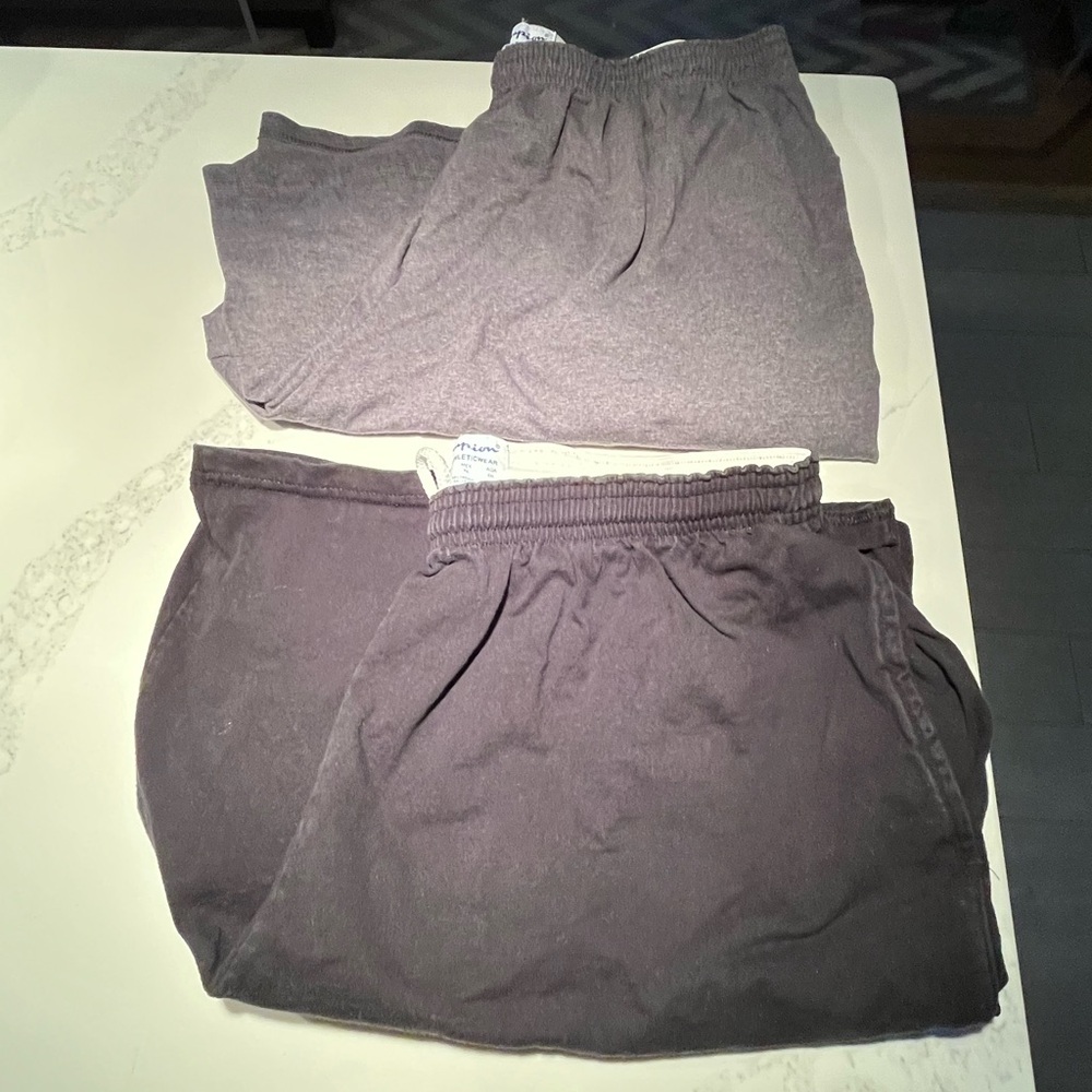 Two pair of men’s Champion shorts. All cotton black and gray shorts. Size XL.